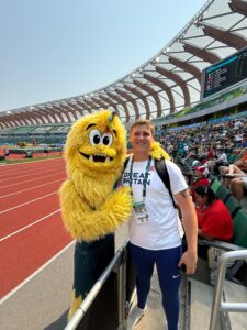 Photo of Wyatt Larkins with the mascot at the World U/20 championships in Oregon